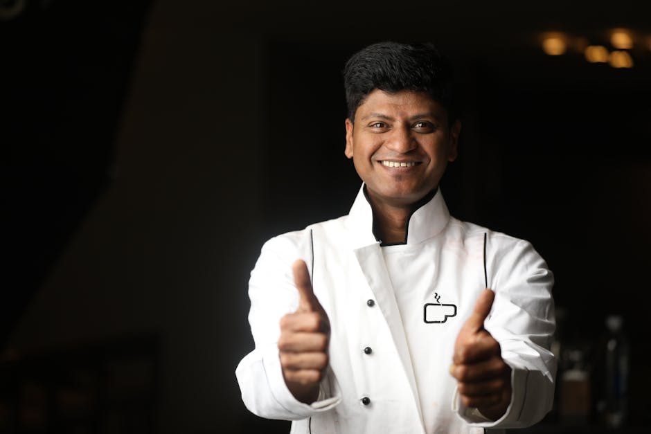 A cheerful chef in a white uniform giving a thumbs up, capturing the spirit of hospitality in Bengaluru.