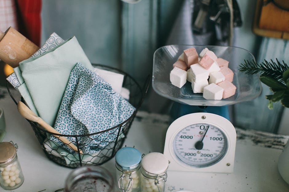 A charming kitchen setup showcasing baking essentials and sugar cubes on a scale.